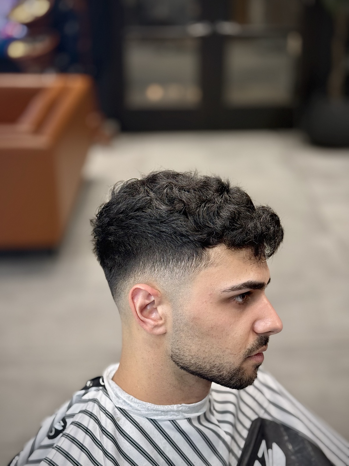 Mid fade with textured curls on top